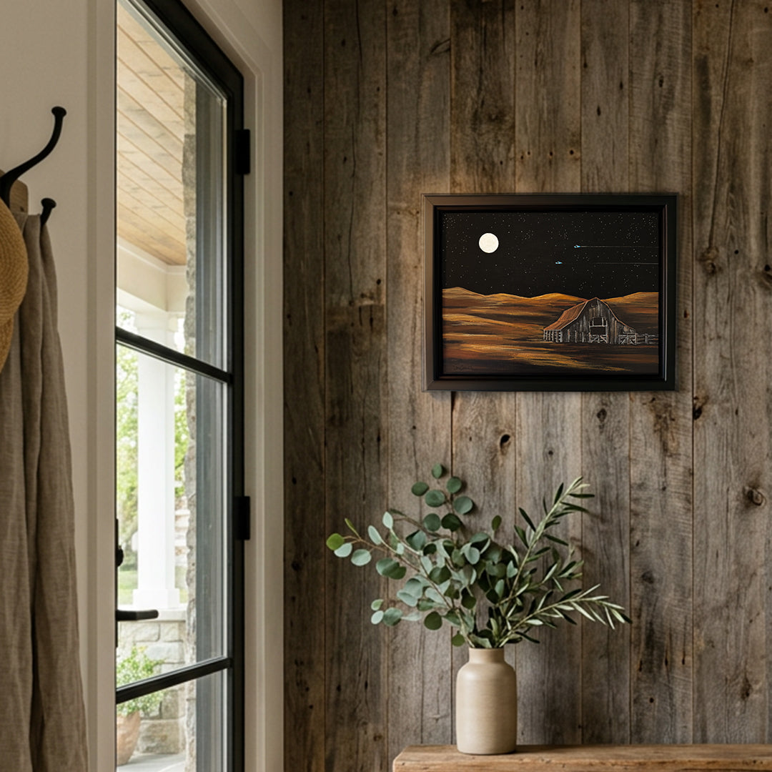 Running Silent, an acrylic painting by Denise Marta-Burch hangs on a rustic barn wood wall by a window.